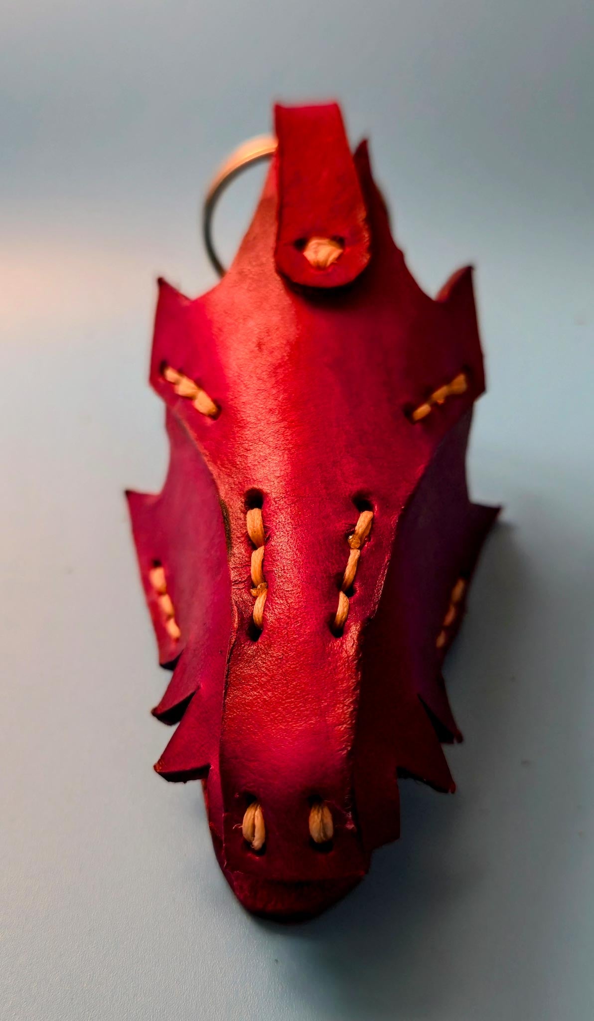Handmade leather dragon keychain with a sturdy chrome key ring, featuring a detailed dragon design on genuine hide.