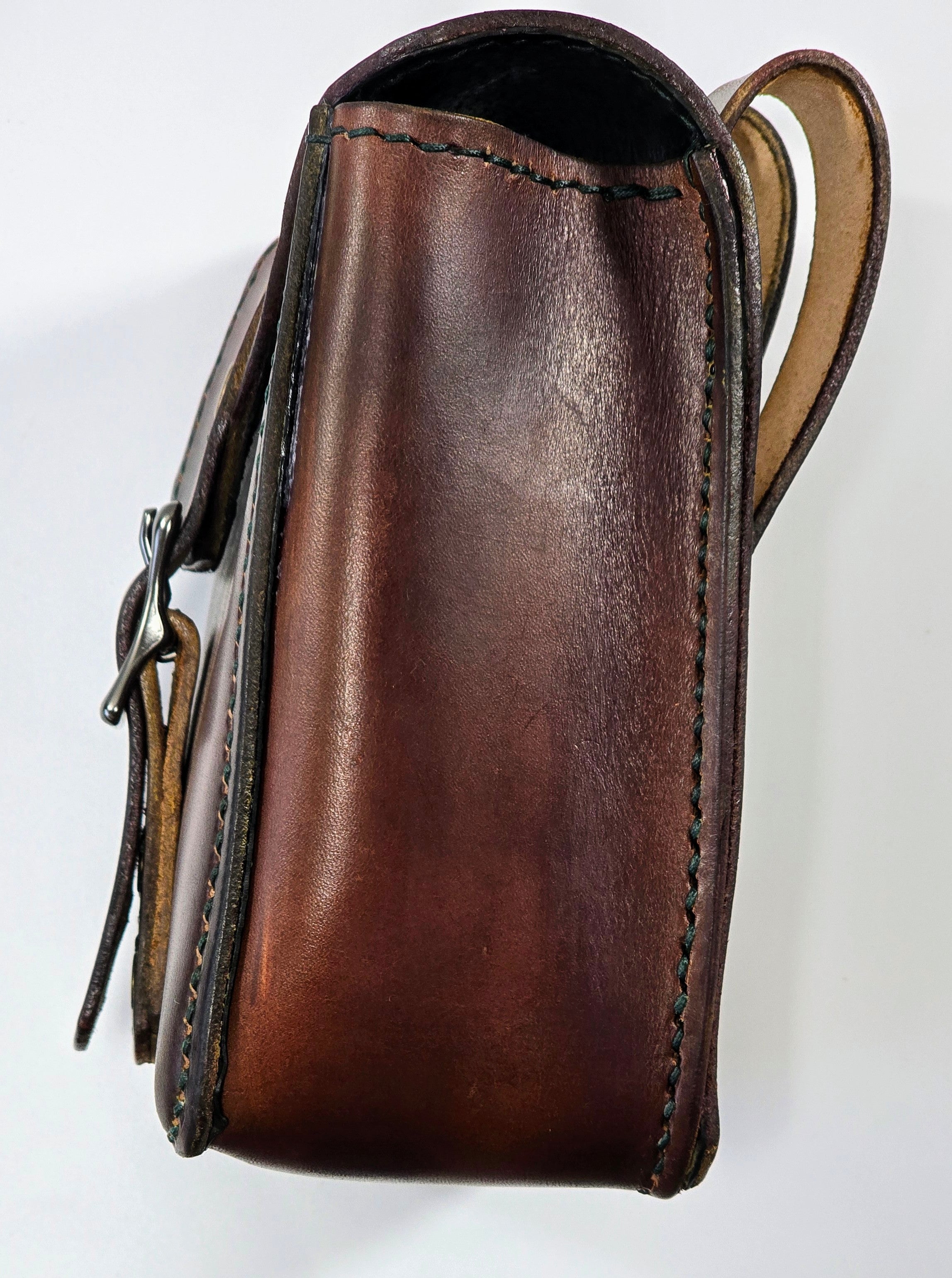 Brown leather pouch with a strap on a white background
