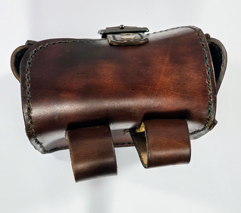 Brown leather pouch with strap on a white background