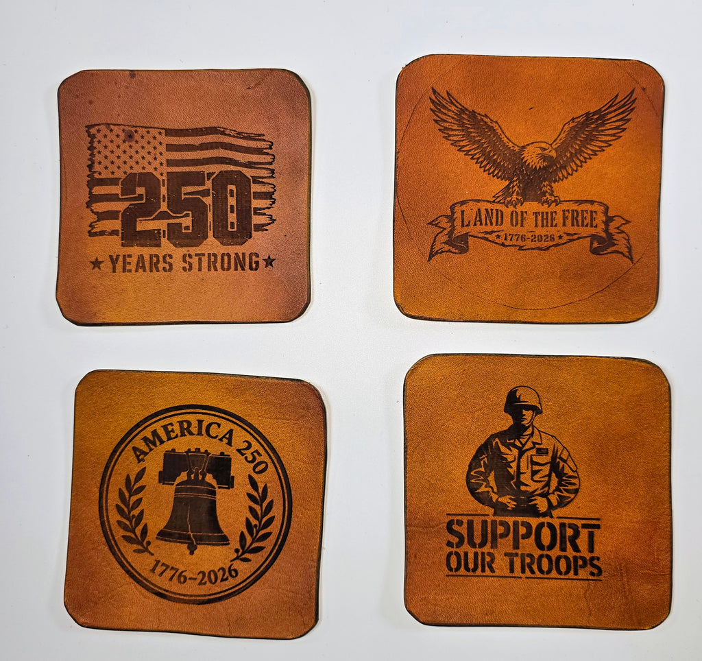 Flat lay of laser-engraved leather coasters from The Kilted Leatherworker, 4x4 inch square, rustic tan finish