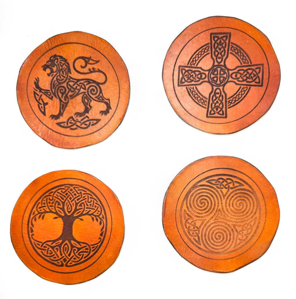 Set of 4 handmade full-grain vegetable tanned leather coasters featuring Celtic knotwork designs – Celtic lion, Celtic cross, Tree of Life, and triskelion spiral