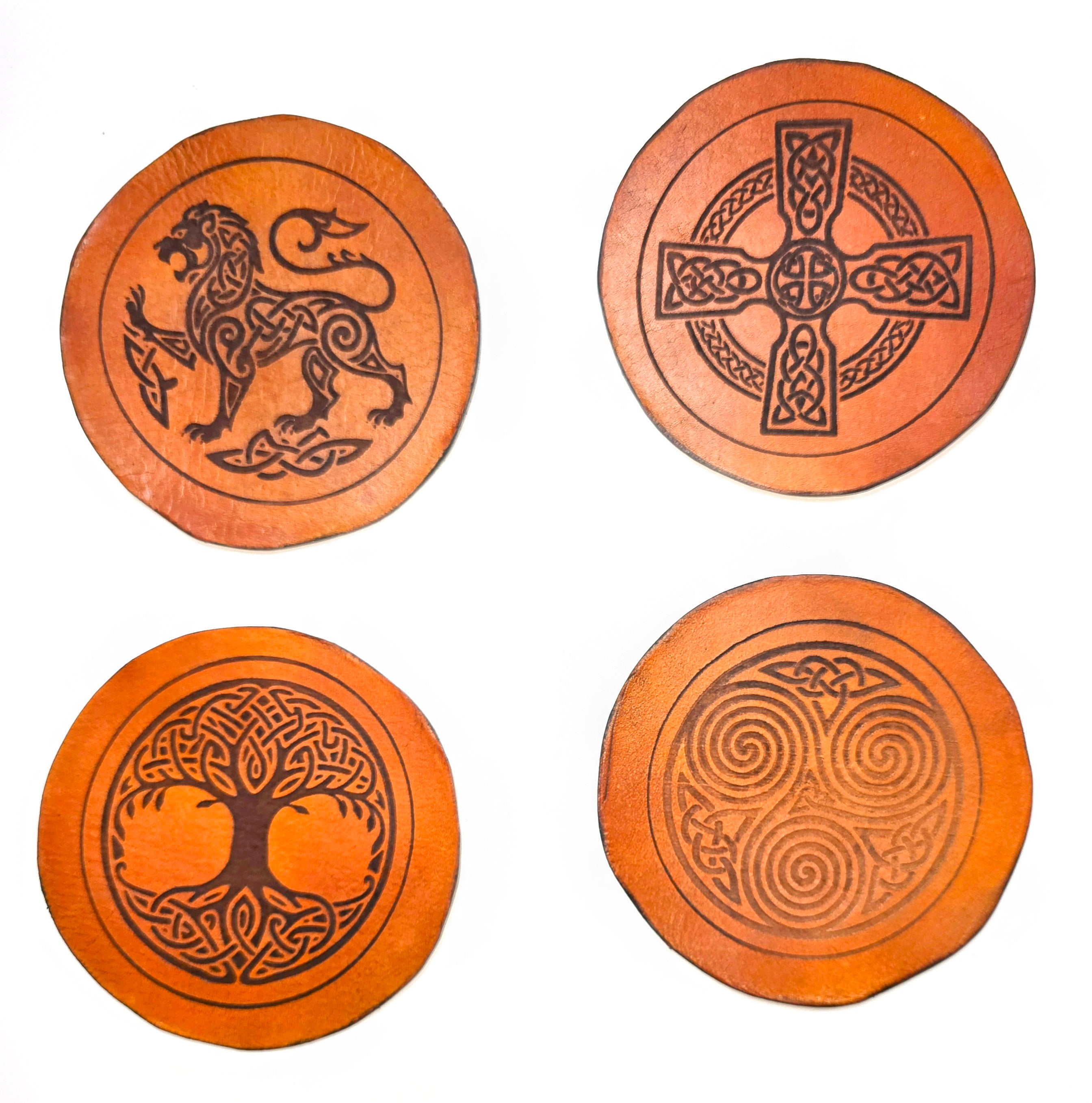 Set of 4 handmade full-grain vegetable tanned leather coasters featuring Celtic knotwork designs – Celtic lion, Celtic cross, Tree of Life, and triskelion spiral