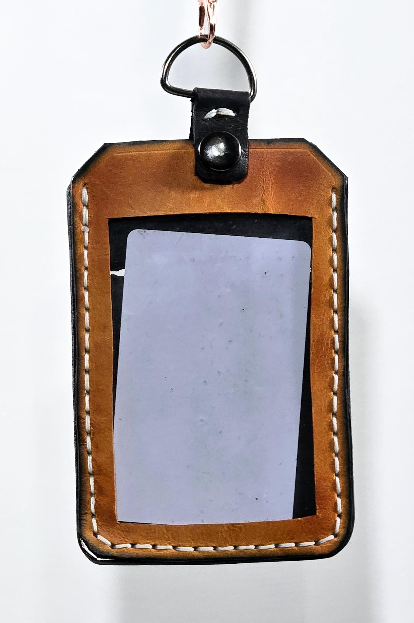 Brown leather ID badge holder on a white background