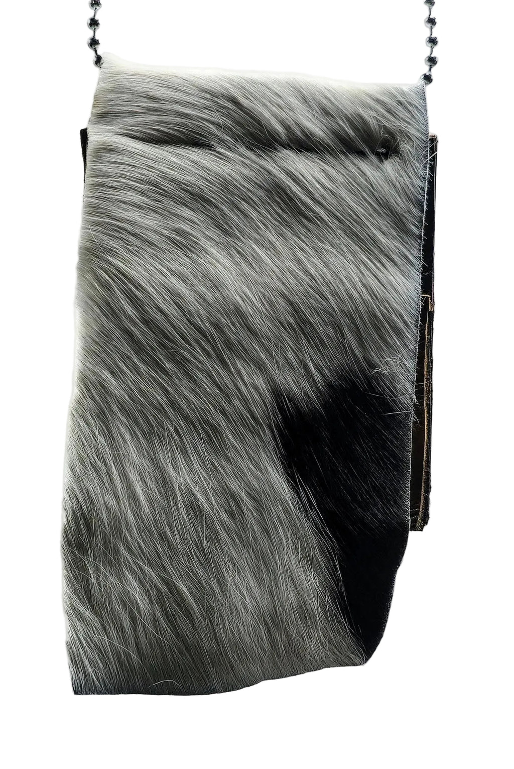 Close-up of a hair-on-hide leather badge holder with genuine cowhide texture and clean, reinforced stitching