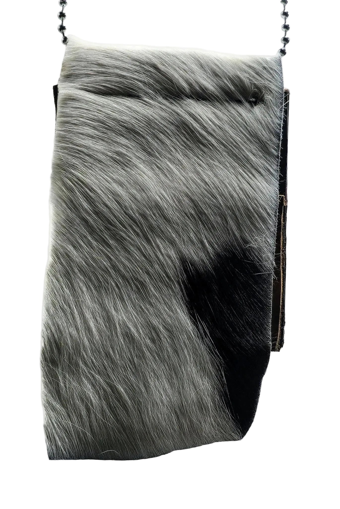 Close-up of a hair-on-hide leather badge holder with genuine cowhide texture and clean, reinforced stitching