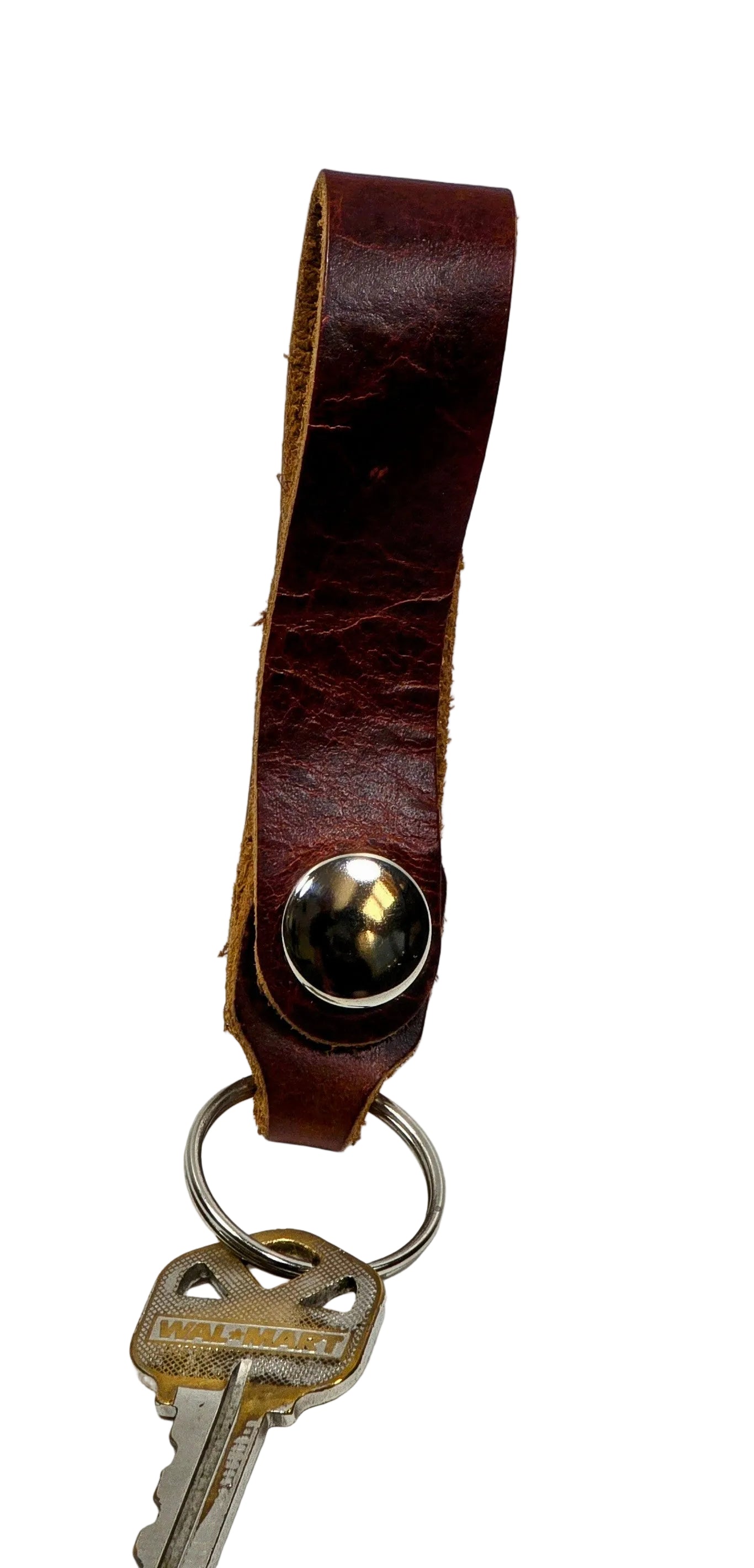Brown leather key fob with a key on a white background