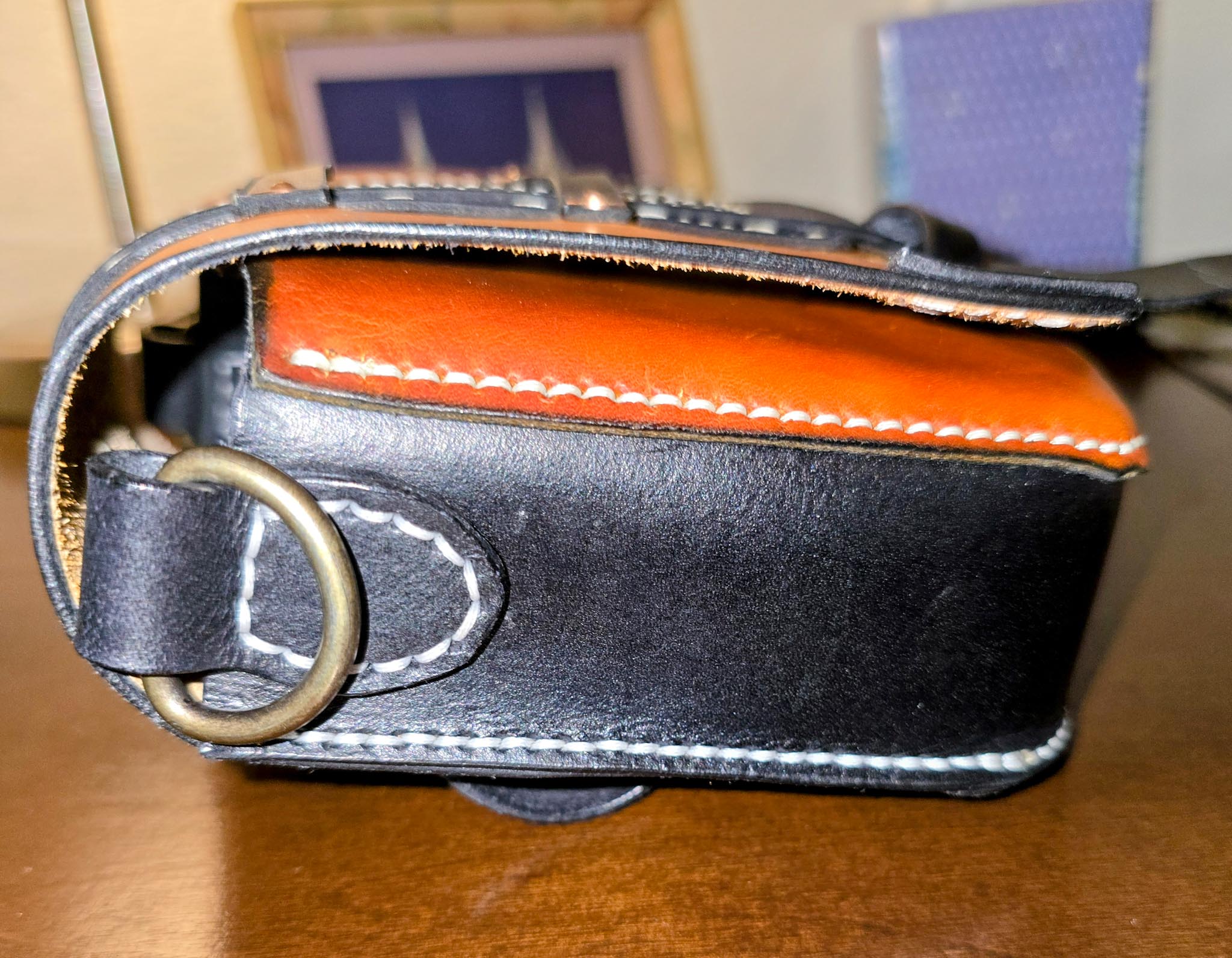 Close-up of a leather viking style pouch with a ring on a wooden surface
