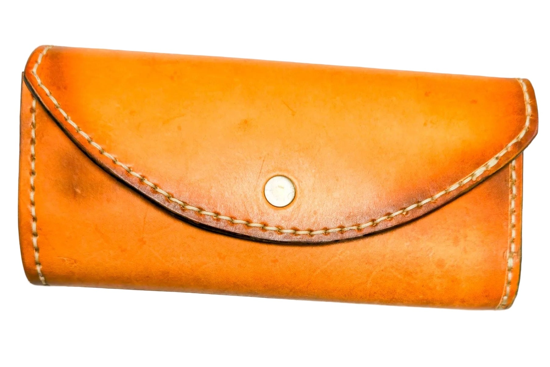 Tan leather clutch wallet on a white background